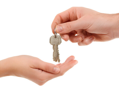 A tall stack of old hardcover books with different colored spines against a black background