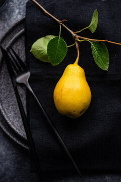 Top view minimalistic pear on a black table setting