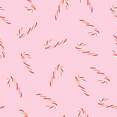 Tossed candy canes on pink seamless pattern. Simple Christmas background. Cute minimalist holiday design for wrapping paper, fabric, wallpaper.