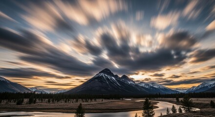Dramatic Long Exposure of a Majestic Mountain Landscape with a Winding River at Sunset
