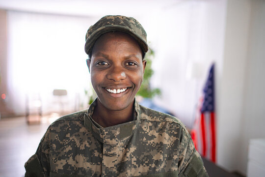 Portrait of smiling african american female soldier in camouflage uniform