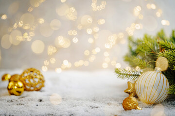 Christmas Holiday background with snow, fir tree and decorations with christmas light behind....