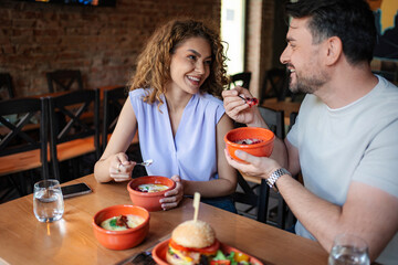 Happy couple enjoying a meal together at a restaurant
