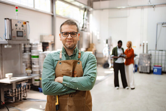 Man brewer owner portrait standing in craft brewery - Powered by Adobe