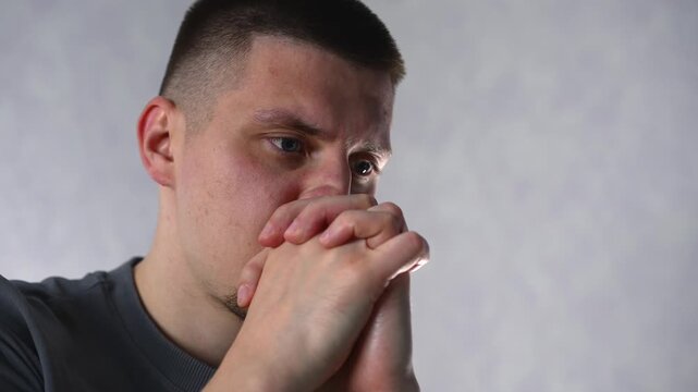 Heartache and fear are evident in the young man's facial expressions.
The man found himself in a difficult situation due to problems and debt.
The man is stressed and depressed due to life's difficult