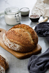 Freshly Baked Artisan Bread on Wooden Board in Rustic Kitchen Setting