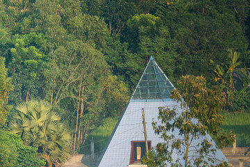 A pyramid structure nestled amidst dense forest greenery