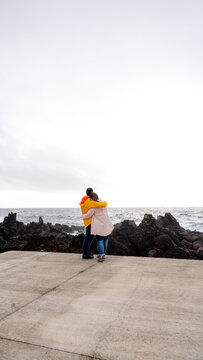 Couple embracing at rocky ocean view in Azores