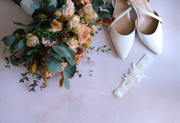 Rings, earrings, bouquet, bridal shoe