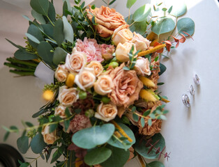 Rings, earrings, bouquet, bridal shoe