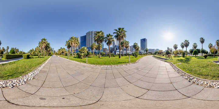 360 seamless hdri panorama view on pedestrian path near seashore or ocean with skyscrapers with blue sky and good weather in equirectangular spherical projection, ready AR VR virtual reality content