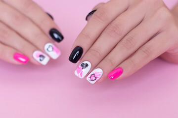 
Beautiful female hands with fashion manicure nails, hearts and Valentine's day design, on pink background