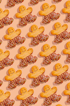 Gingerbread cookie pattern with sprinkles on beige background
