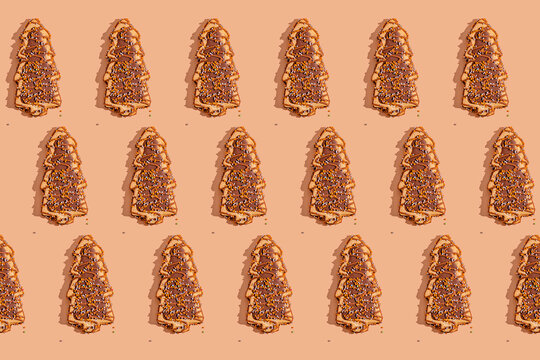Gingerbread Christmas tree cookies on beige background