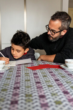 Father and child writing letters to Santa and Wise Men