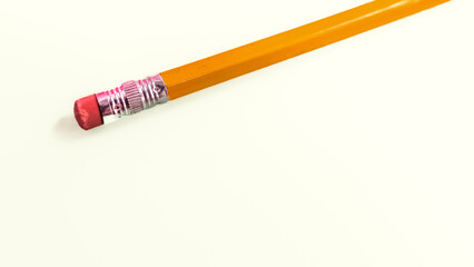 a standard yellow wooden pencil isolated on a white hue background with soft focus. metal ferrule and a pink eraser. education template, banner or background with copy space.