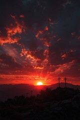 Dramatic sunset ablaze with fiery clouds illuminates three crosses on a rocky hilltop, symbolizing hope and sacrifice