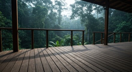 Wooden deck overlooking lush, misty jungle canopy at sunrise