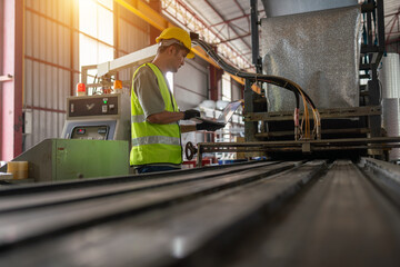 Industrial worker operating machinery in factory manufacturing process warehouse environment technical overview