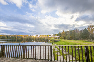 Wooden fence overlooks a lake with a wooden dock