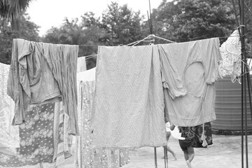 Washing line with drying clothes in outdoor. Clothes hanging on washing line in outdoor.