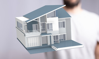 A man holding a model house, symbolizing real estate, home ownership dreams, and the future. Great for property, housing and investment visuals.