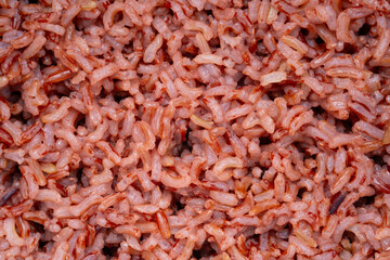 Close up cooked Thai Organic Red Jasmine Rice texture for background.semi-milled rice.