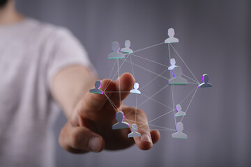 Conceptual image of a person touching a digital network of people, representing social connections, teamwork, and communication. Ideal for techn