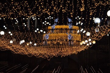 Obraz premium Preparing for the holiday. New Year's garlands are hung throughout the city.