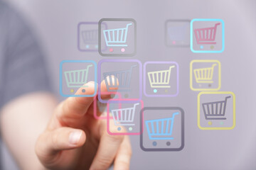 A finger selects a shopping cart icon on a screen, representing online shopping, sales and e-commerce. Perfect for web design and retail themes.