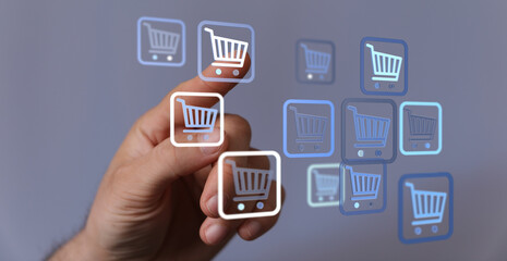Hand touching digital shopping cart icons, representing online shopping, e-commerce, and buying concepts. Illustrates a user's experience of dig