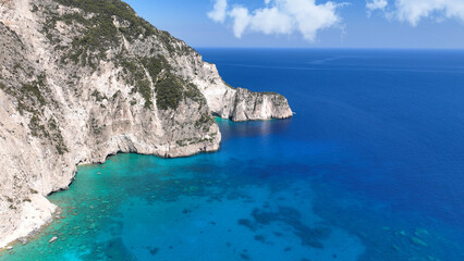 Aerial drone photo of paradise tropical island surrounded with limestone white cliffs forming a blue lagoon and sea caves with turquoise crystal clear sea
