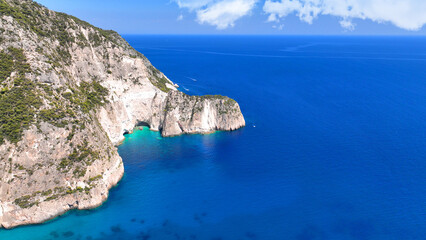Aerial drone photo of iconic paradise azure caves of Keri forming a blue lagoon visited by small boats and yachts a true summer tourist destination in island of Zakinthos, Ionian, Greece