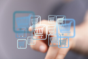 Person's finger touching an online shopping cart icon. E-commerce and digital shopping concept for sales and marketing. Modern lifestyle and ret