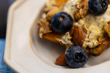 Creative dish with blueberry nut yogurt and roasted sweet potato