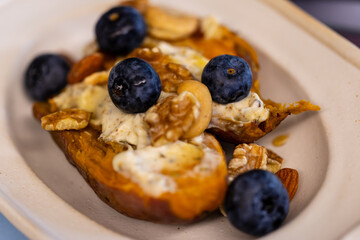 Creative dish with blueberry nut yogurt and roasted sweet potato