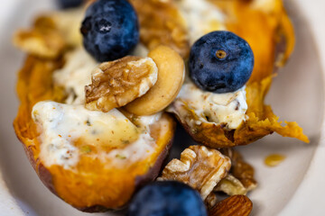 Creative dish with blueberry nut yogurt and roasted sweet potato