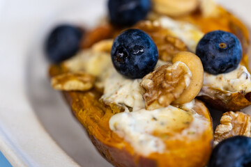 Creative dish with blueberry nut yogurt and roasted sweet potato