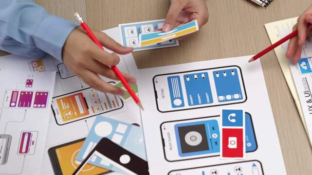 Top view panorama video of startup company employee planning on user interface prototype for mobile application or website in office. UX UI designer brainstorm user friendly interface plan. Synergic