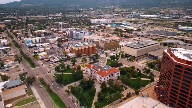 Approaching the building of Colorado Springs Pioneers Museum with a clock tower on top. Vast scenery of the city at backdrop.