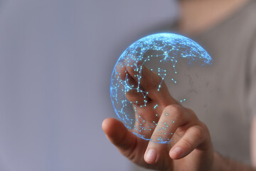 Person touching a digital globe representing connectivity, networking, and the future. Visual representation of global communication and data tr