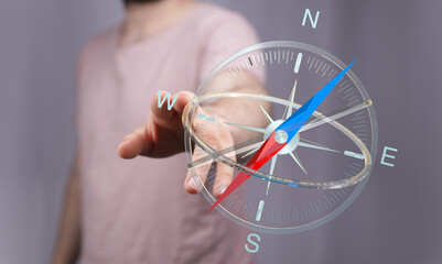 A person's hand interacting with a digital compass, highlighting navigation, direction, and...