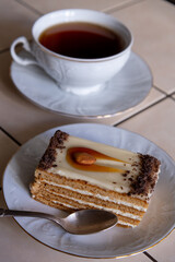 Enjoying a delicious slice of cake with a cup of tea on a sunny afternoon