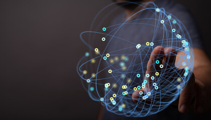 Close-up of hand touching a glowing sphere representing network, data, and technology, conveying connectivity and innovation. Suitable for busin