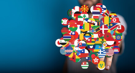A person holding a sphere of various country flags representing global unity, international cooperation, and world connections. This image evoke