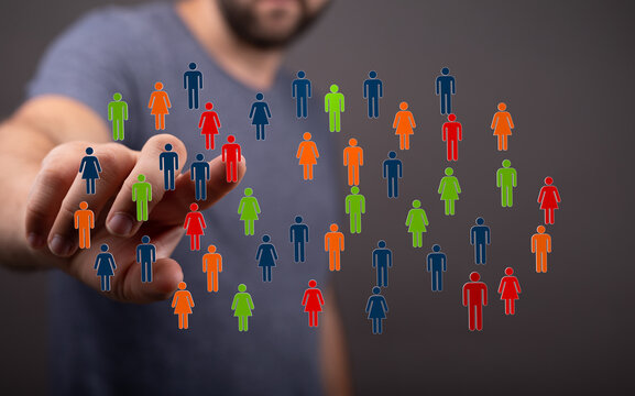 Hand reaching towards a collection of diverse human figures representing teamwork, community, and connection.