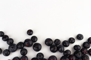 Blueberries scattered on a white background.