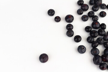 Blueberries scattered on a white background.