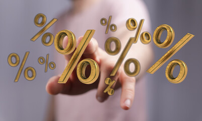 Close up shot of a hand interacting with golden percentage symbols, representing financial concepts...