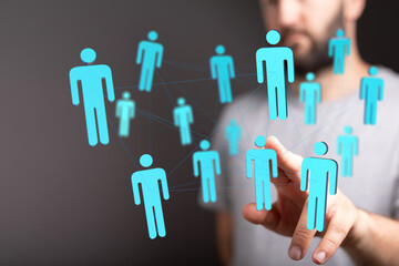 Visual representation of connection network concept, person's hand interacting with virtual human figures, representing social media, teamwork a